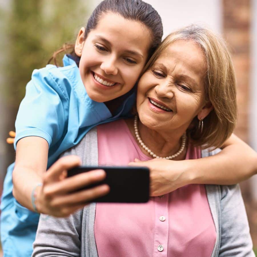 Edition of Saginaw | Senior woman taking a photo with caregiver